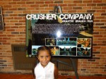 Flor, in front of one of the posters about Andy's company, "Crusher Company."